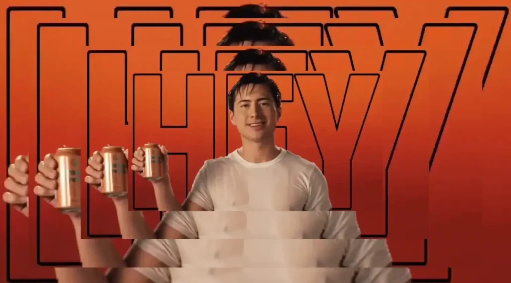 Shane Hollander holding a soft drink and wearing a wet t-shirt. The word HEY is outlined behind him on a orange background. This is the cover image of the iconic Big Ole Freak Heated Rivalry edit by (im)sosaneitsinsane.